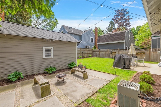 view of yard featuring an outdoor fire pit and a patio