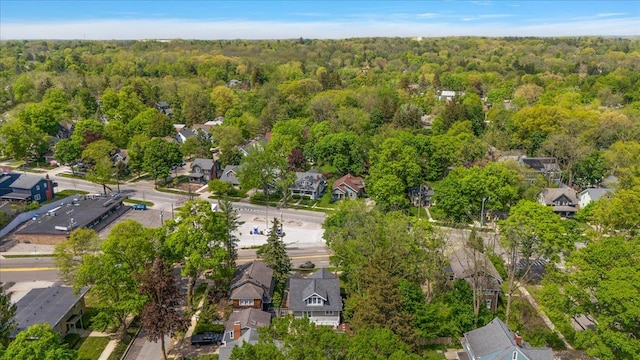 view of property location with a forest and nearby suburban area