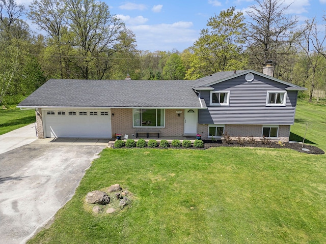 9703 Tower Rd, South Lyon, MI 48178 - split level home with driveway, a garage, brick siding, and a front lawn