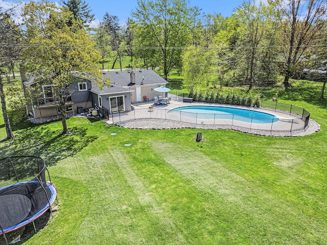 9703 Tower Rd, South Lyon, MI 48178 - view of swimming pool featuring a trampoline and a patio area
