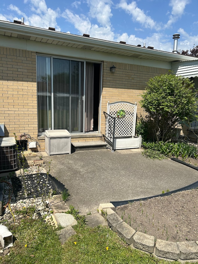 49936 Helfer Blvd Unit 8, Wixom, MI 48393 - rear view of property featuring brick siding and a patio