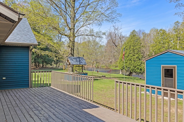 8869 E Hawley Rd, Hesperia, MI 49421 - wooden deck featuring a yard, an outbuilding, a storage shed, and view of scattered trees