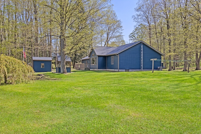 8869 E Hawley Rd, Hesperia, MI 49421 - view of green lawn featuring an outbuilding and a storage shed