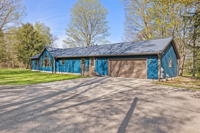 8869 E Hawley Rd, Hesperia, MI 49421 - ranch-style house with an attached garage, driveway, and a front yard