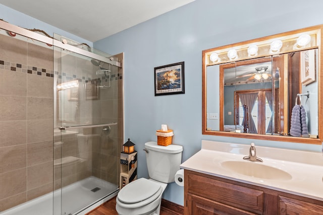 8869 E Hawley Rd, Hesperia, MI 49421 - full bathroom featuring a shower stall, toilet, vanity, and ceiling fan