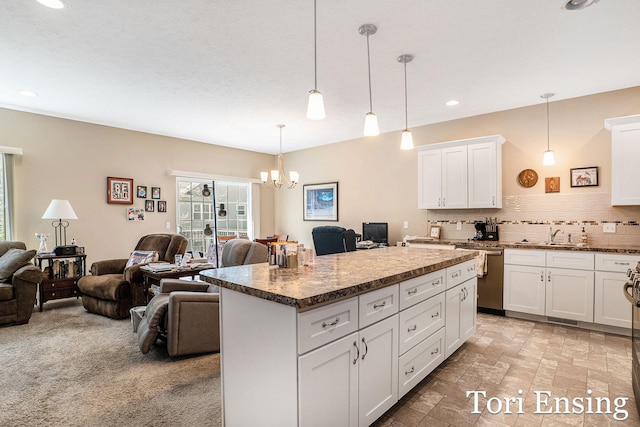 1026 Grosvenor Dr Unit 27, Greenville, MI 48838 - kitchen with open floor plan, stainless steel dishwasher, a chandelier, tasteful backsplash, and recessed lighting