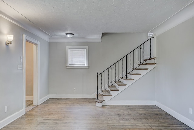 18613 Santa Rosa Dr, Detroit, MI 48221 - entryway with wood finished floors, a textured ceiling, stairs, and baseboards