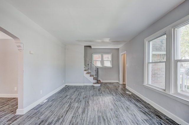 18644 Santa Rosa Dr, Detroit, MI 48221 - unfurnished living room with wood finished floors, stairway, healthy amount of natural light, and baseboards