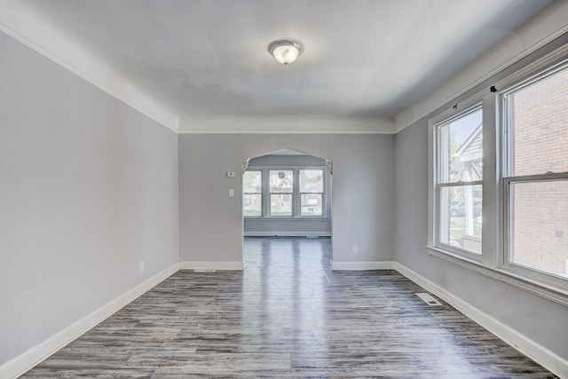 18644 Santa Rosa Dr, Detroit, MI 48221 - spare room with wood finished floors, baseboards, arched walkways, and crown molding