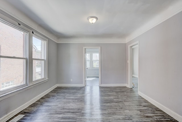 18644 Santa Rosa Dr, Detroit, MI 48221 - spare room featuring dark wood-type flooring, baseboards, and crown molding
