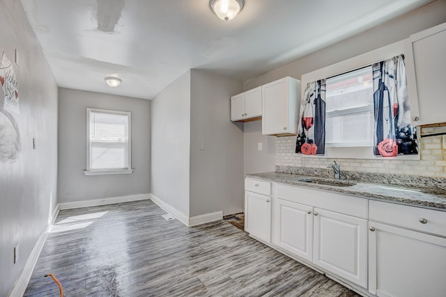 18644 Santa Rosa Dr, Detroit, MI 48221 - kitchen featuring baseboards, decorative backsplash, white cabinets, and light wood-type flooring