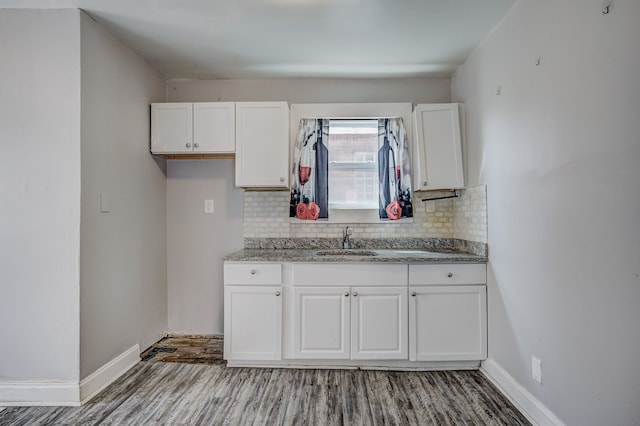 18644 Santa Rosa Dr, Detroit, MI 48221 - kitchen with a sink, decorative backsplash, white cabinetry, and light wood finished floors