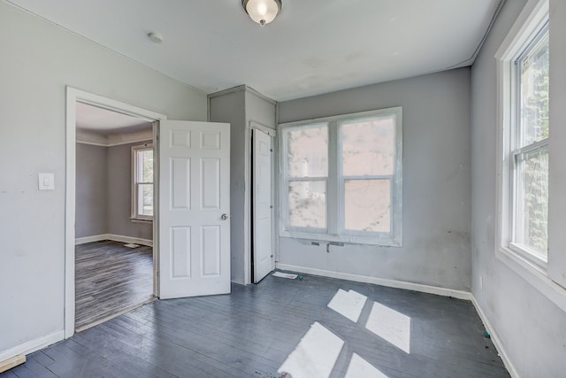 18644 Santa Rosa Dr, Detroit, MI 48221 - unfurnished bedroom with dark wood-style floors and baseboards