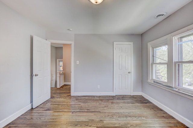 18644 Santa Rosa Dr, Detroit, MI 48221 - unfurnished bedroom with baseboards, light wood-style floors, and a closet