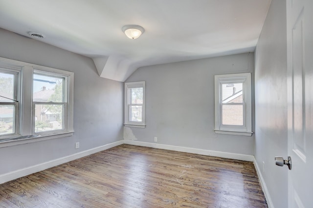 18644 Santa Rosa Dr, Detroit, MI 48221 - empty room with wood finished floors, baseboards, and vaulted ceiling