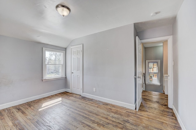 18644 Santa Rosa Dr, Detroit, MI 48221 - unfurnished bedroom featuring wood finished floors, vaulted ceiling, baseboards, and a closet