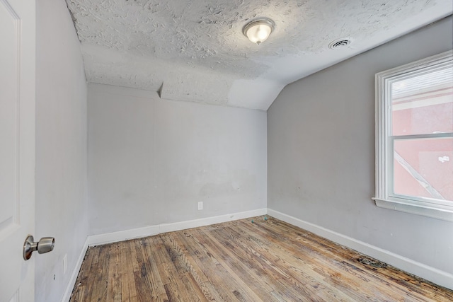18644 Santa Rosa Dr, Detroit, MI 48221 - additional living space featuring lofted ceiling, wood finished floors, baseboards, and a textured ceiling