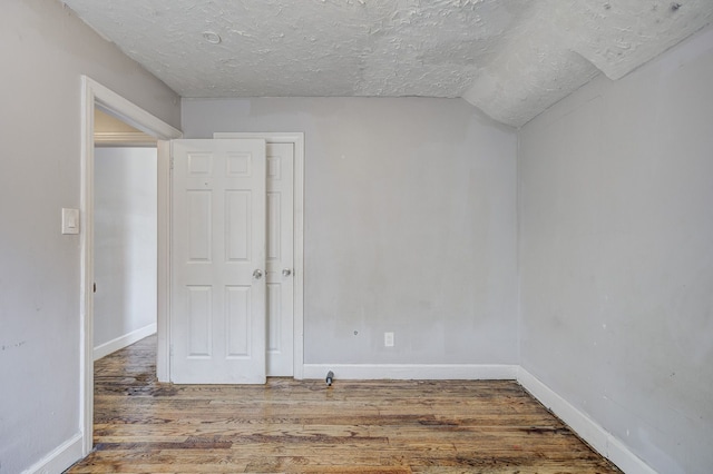 18644 Santa Rosa Dr, Detroit, MI 48221 - unfurnished room featuring wood finished floors, a textured ceiling, and baseboards