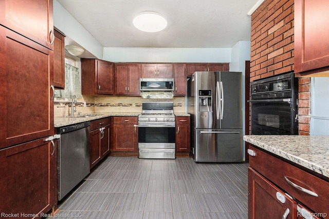 28015 Loretta Ave, Warren, MI 48092 - kitchen featuring appliances with stainless steel finishes, a sink, tasteful backsplash, and light stone countertops