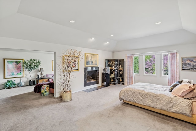 bedroom featuring lofted ceiling, carpet flooring, a fireplace, recessed lighting, and baseboards