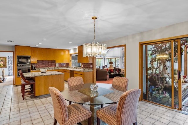 dining space featuring a chandelier and recessed lighting