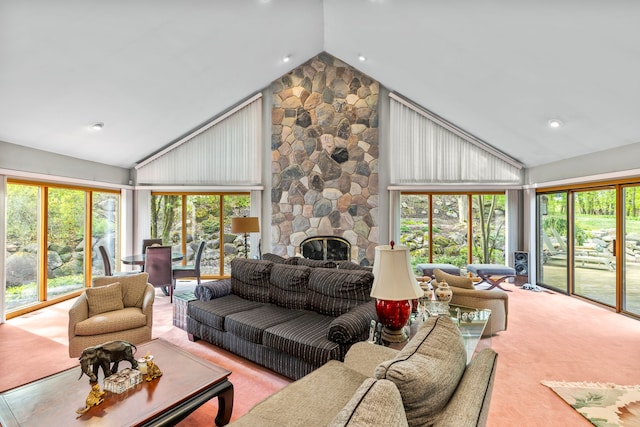 living area featuring high vaulted ceiling, plenty of natural light, carpet floors, and a fireplace