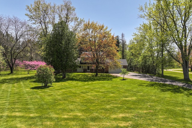 4111 Pratt Rd, Metamora, MI 48455 - view of grassy yard with concrete driveway and a garage