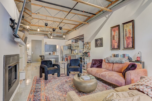 111 N Main St Unit 209, Royal Oak, MI 48067 - living area with a towering ceiling, finished concrete floors, and a fireplace