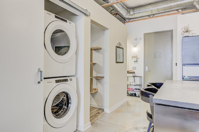111 N Main St Unit 209, Royal Oak, MI 48067 - clothes washing area with stacked washing machine and dryer and baseboards
