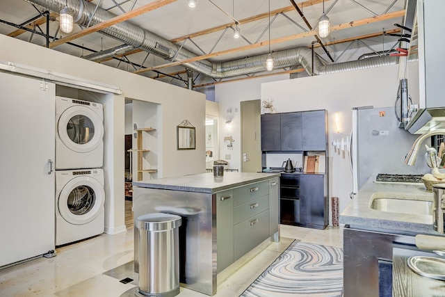 111 N Main St Unit 209, Royal Oak, MI 48067 - laundry area with stacked washer / dryer and a high ceiling