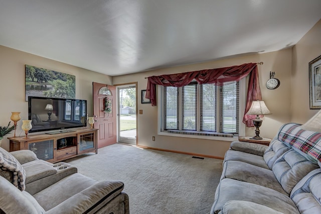 carpeted living room with baseboards