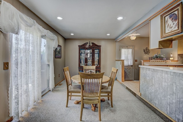 dining space featuring light carpet and recessed lighting