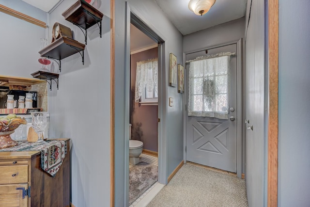 doorway to outside featuring baseboards