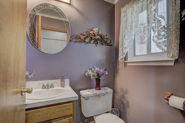 bathroom with toilet and vanity