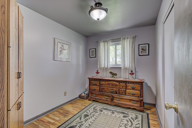 bedroom featuring light wood-style flooring and baseboards
