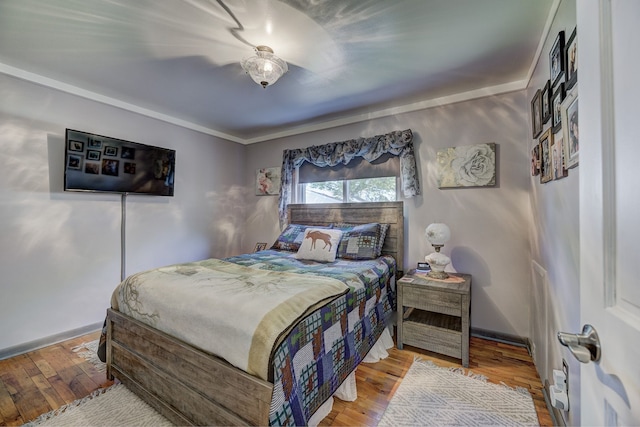 bedroom featuring hardwood / wood-style flooring and baseboards