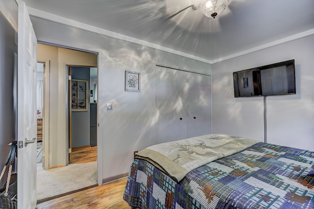 bedroom with light wood finished floors and baseboards