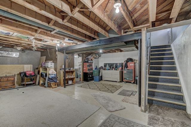 unfinished basement featuring stairs
