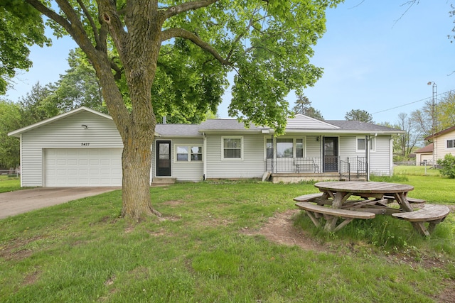 5427 Fiesta Pass, Grand Blanc, MI 48439 - view of front of house featuring a front lawn, an attached garage, driveway, and a porch