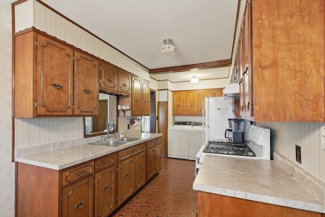 5427 Fiesta Pass, Grand Blanc, MI 48439 - kitchen featuring washing machine and clothes dryer, a sink, brick patterned floors, brown cabinets, and under cabinet range hood