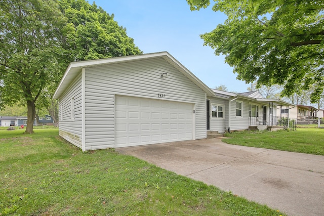 5427 Fiesta Pass, Grand Blanc, MI 48439 - view of front of home featuring an attached garage, a front lawn, and driveway