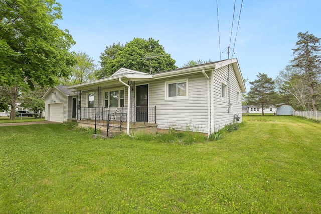 5427 Fiesta Pass, Grand Blanc, MI 48439 - view of front facade with a porch, a front yard, and a garage