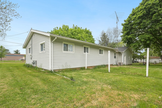 5427 Fiesta Pass, Grand Blanc, MI 48439 - view of property exterior featuring a lawn and central AC