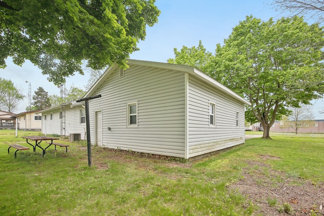 5427 Fiesta Pass, Grand Blanc, MI 48439 - view of home's exterior with a lawn and central AC unit
