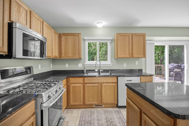 137 Donna, Waterford, MI 48327 - kitchen featuring appliances with stainless steel finishes, a sink, and dark stone countertops