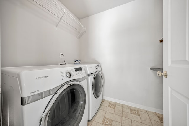 137 Donna, Waterford, MI 48327 - laundry area with washer and dryer, baseboards, and stone tile flooring