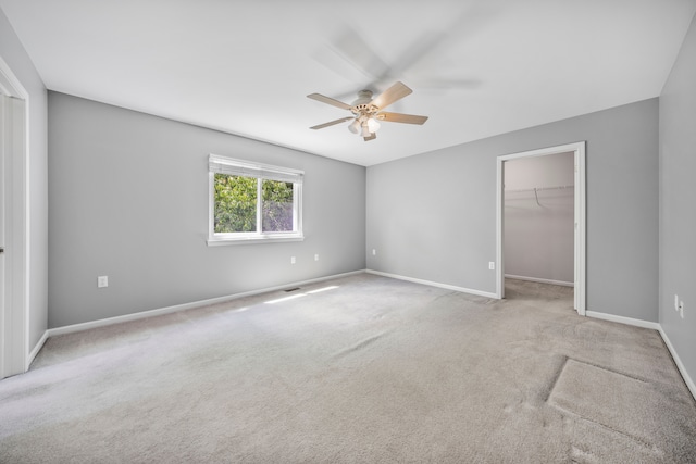 137 Donna, Waterford, MI 48327 - unfurnished bedroom featuring carpet, baseboards, a spacious closet, a ceiling fan, and a closet