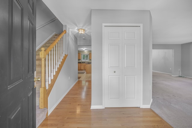 137 Donna, Waterford, MI 48327 - corridor featuring stairs, baseboards, light wood finished floors, and light carpet