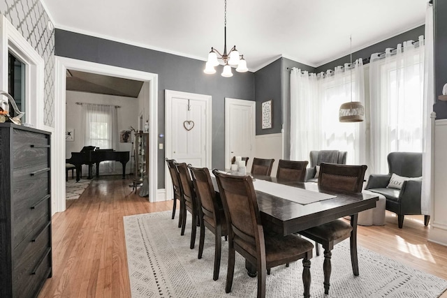 529 Fountain St NE, Grand Rapids, MI 49503 - dining space featuring a chandelier, light wood finished floors, baseboards, and ornamental molding