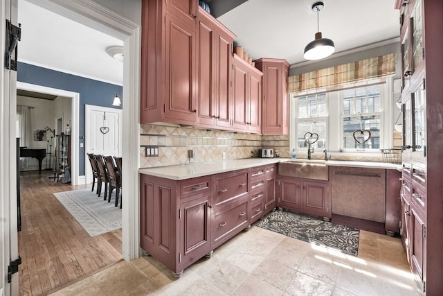 529 Fountain St NE, Grand Rapids, MI 49503 - kitchen with a sink, light countertops, backsplash, crown molding, and hanging light fixtures